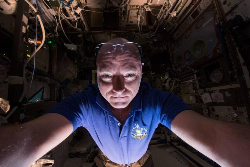 An astronaut floating toward a camera inside the space station