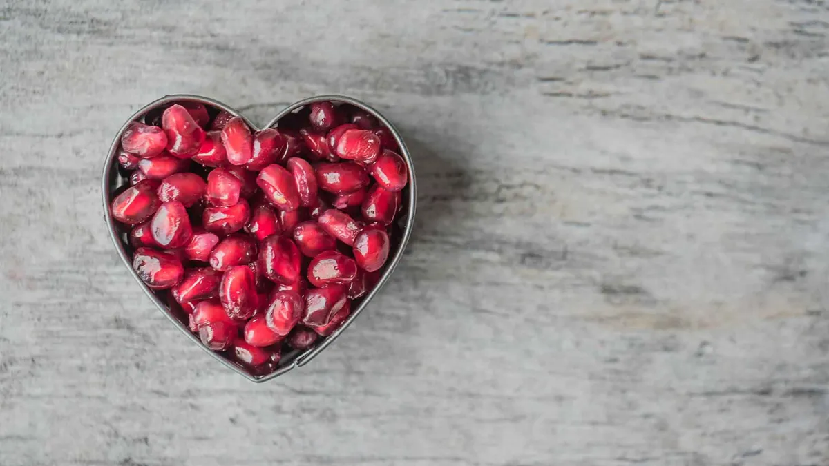Silver Heart Bowl Filled of Red Pomegranate Seeds