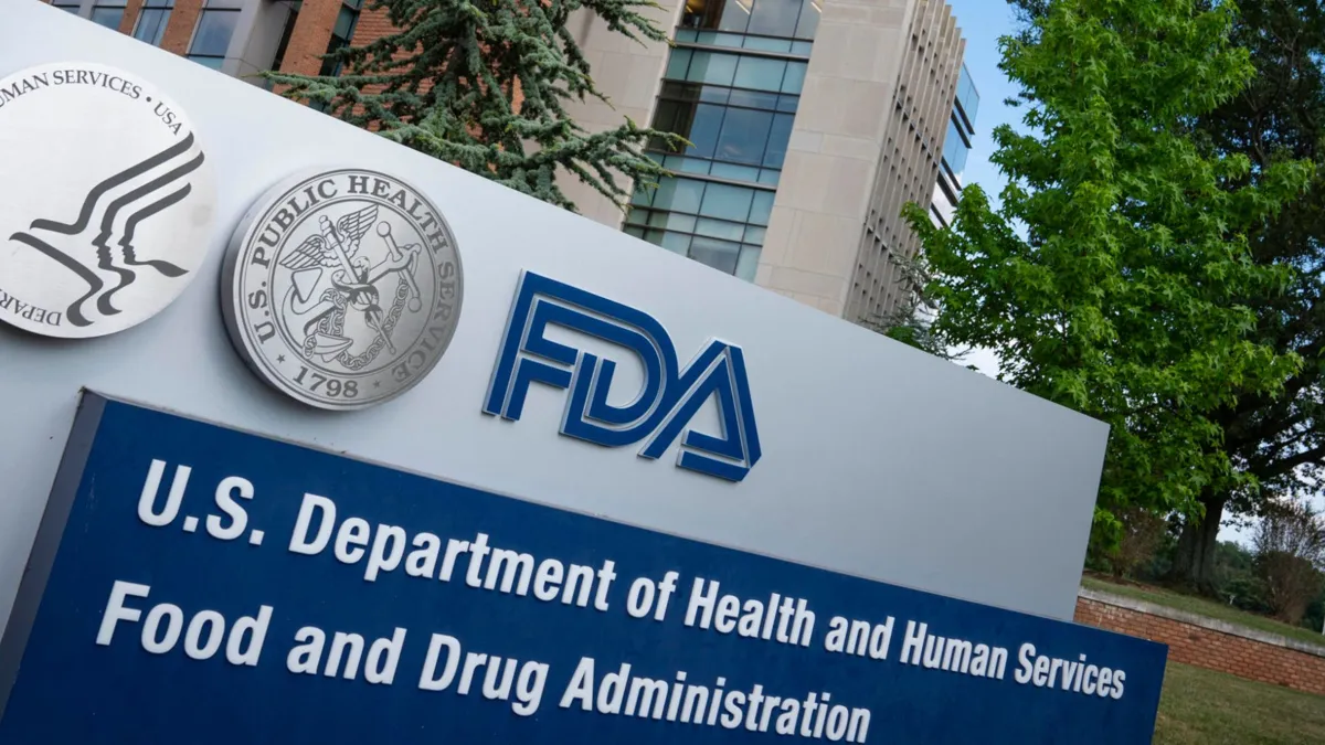 A large blue and silver metal sign displaying official FDA insignia