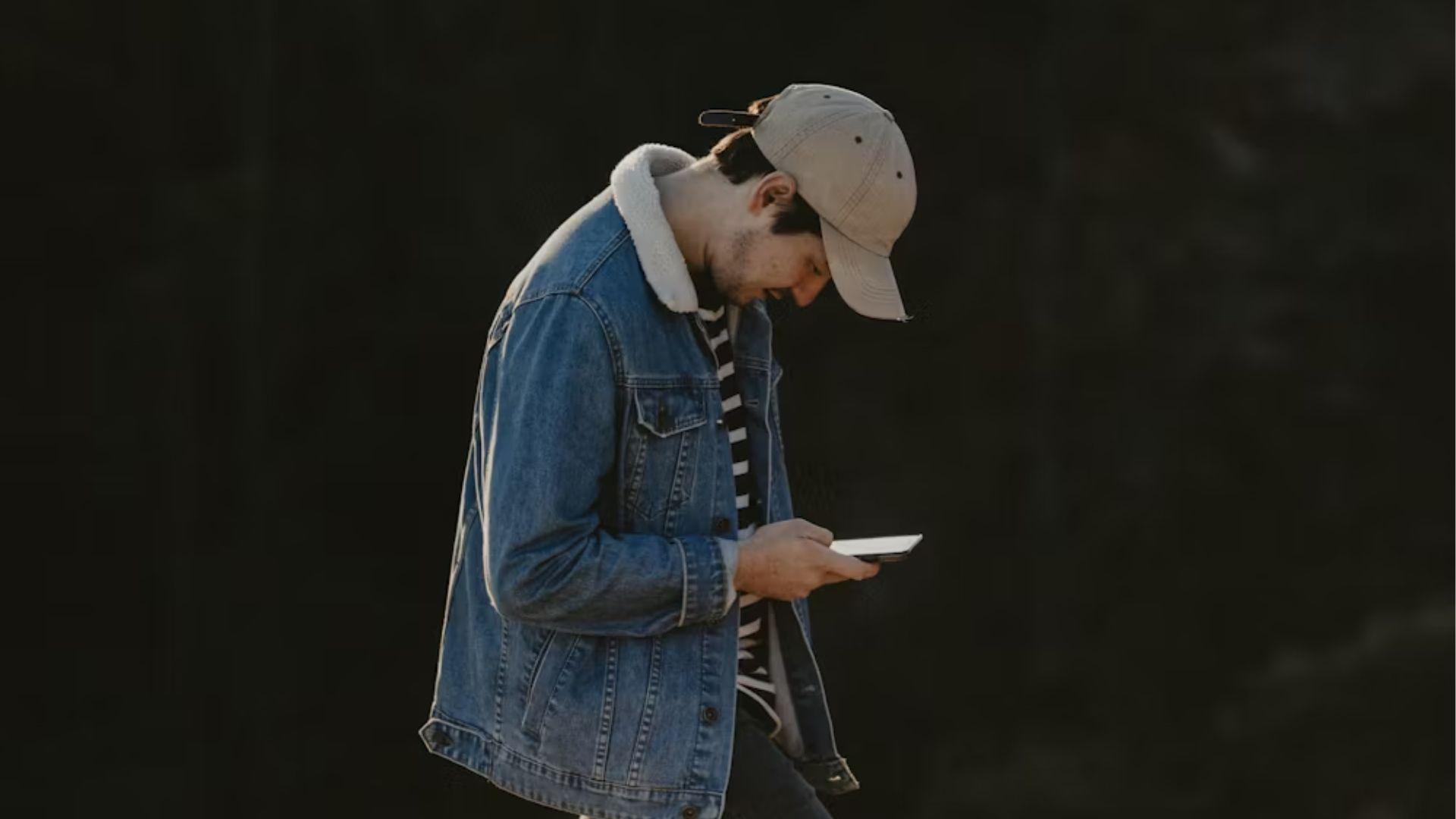 A person looking at a phone; illustrative archive photograph.