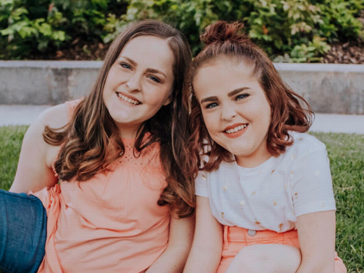 The sisters smiling together in a later archived portrait