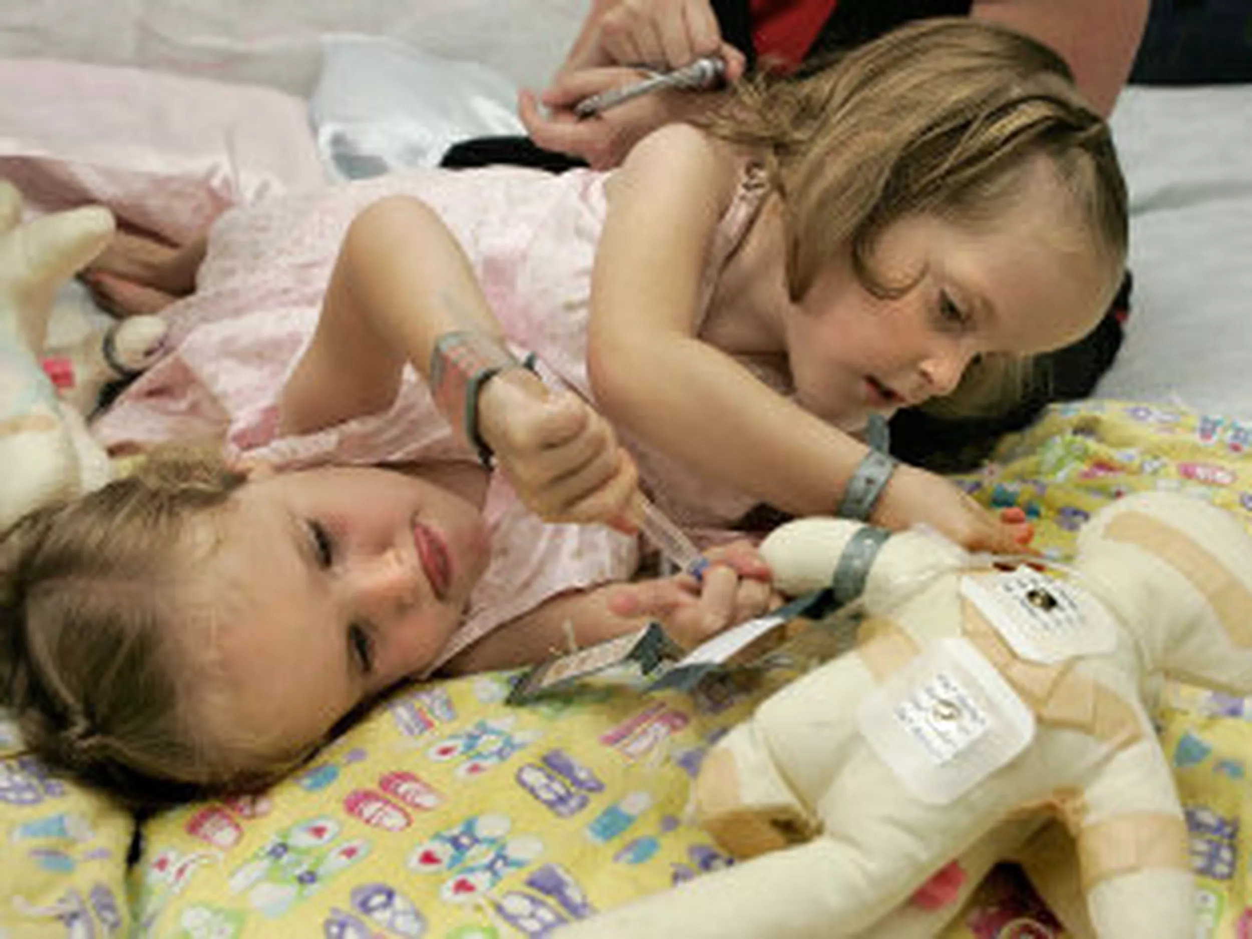 A close view of the twins resting in a hospital bed