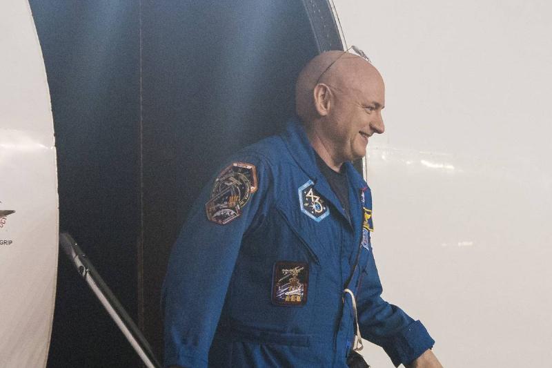 An astronaut in a blue flight suit after leaving a capsule