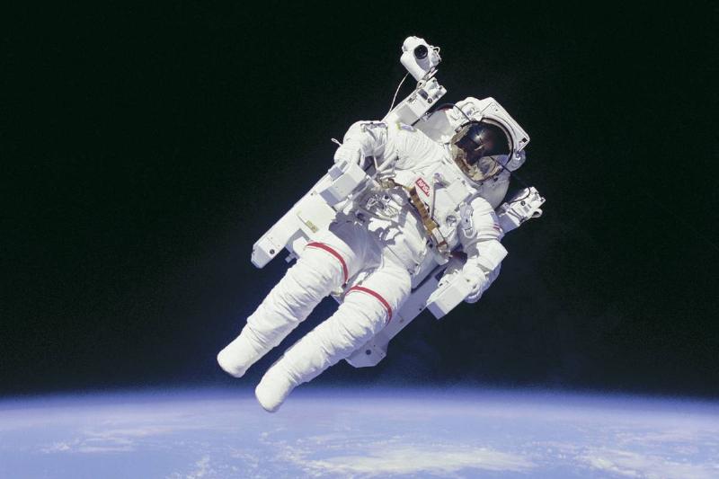 An astronaut above Earth, an archival spaceflight image
