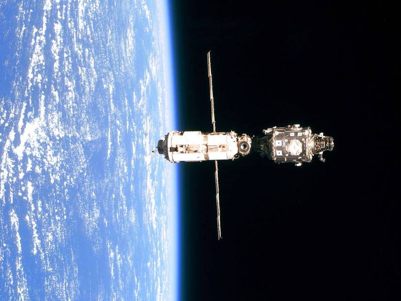 A spacecraft seen in orbit above Earth
