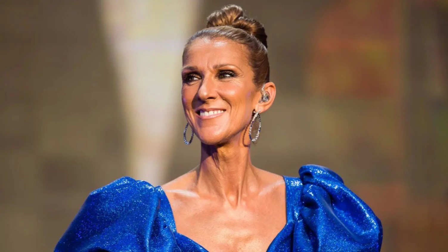 Céline Dion in a blue outfit at a public appearance