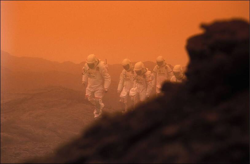 An artist’s depiction of suited explorers on Mars