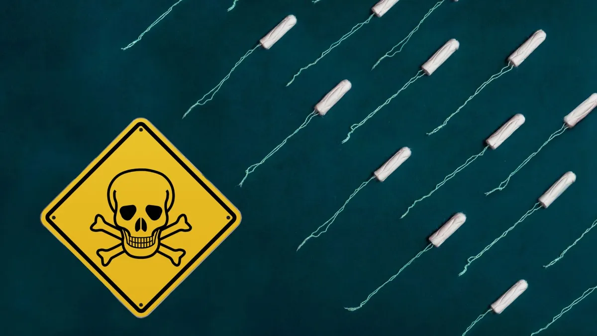 Several tampons on a blue background with a yellow skull and cross bones warning sign