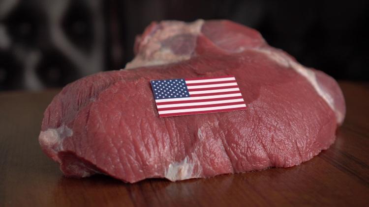Raw meat with a U.S. flag; illustrative archive photograph.