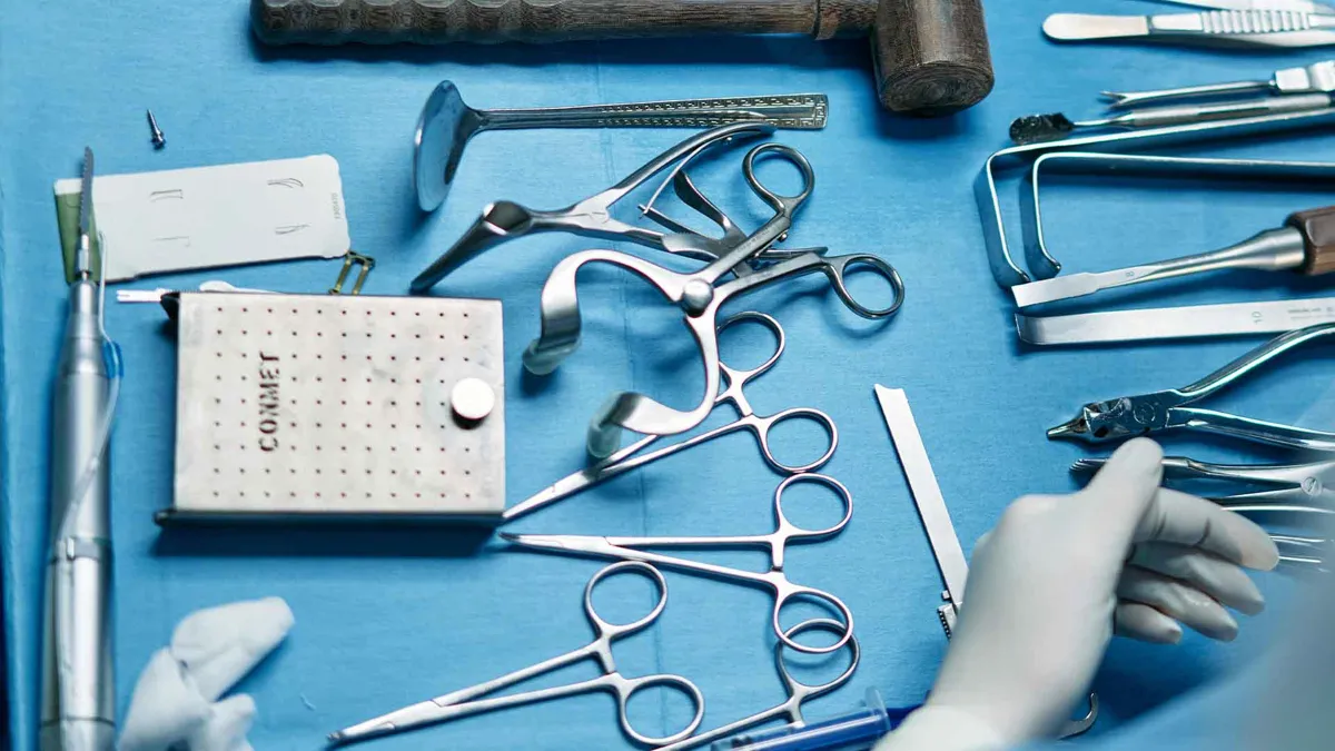 A collection of surgical materials rests on a blue surface