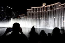 People watching fountains at night; archive photograph.