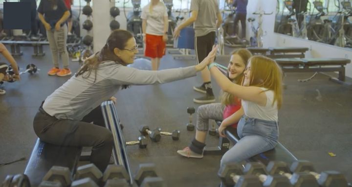 The sisters with a teacher in an archived gym photograph