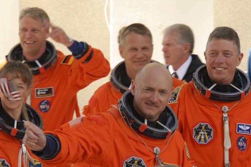 An astronaut crew in orange pressure suits