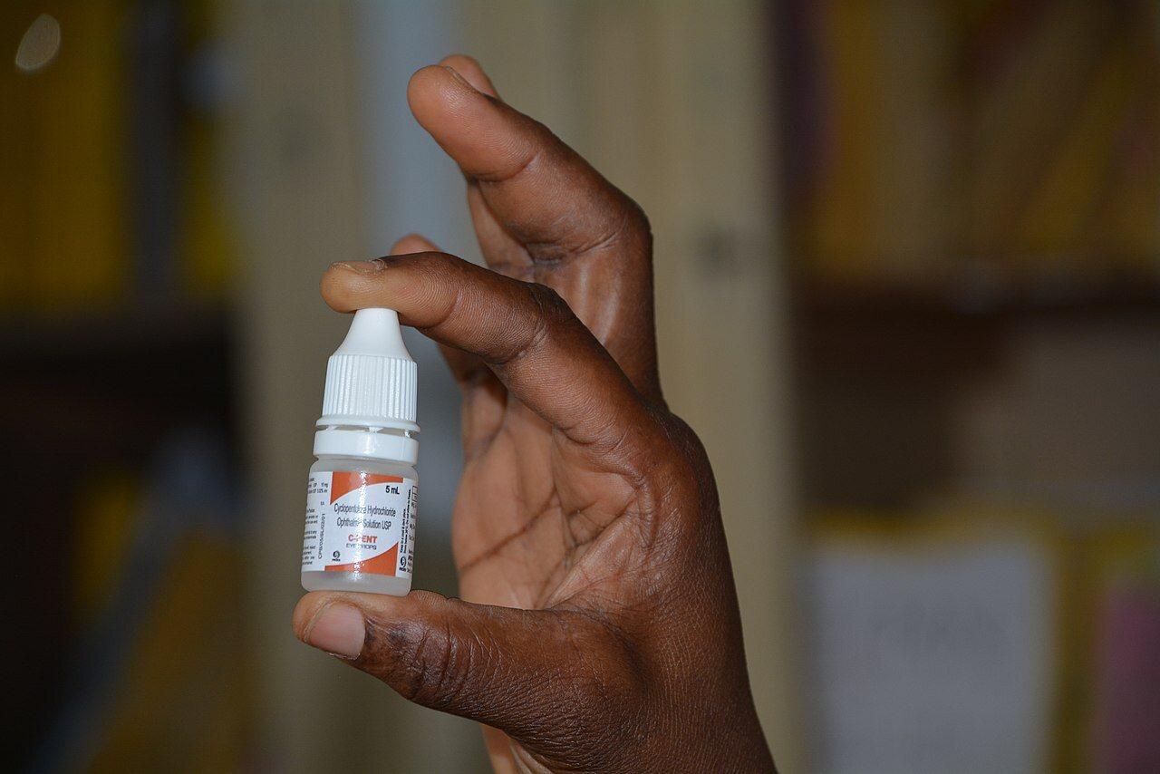 Person using eye drops