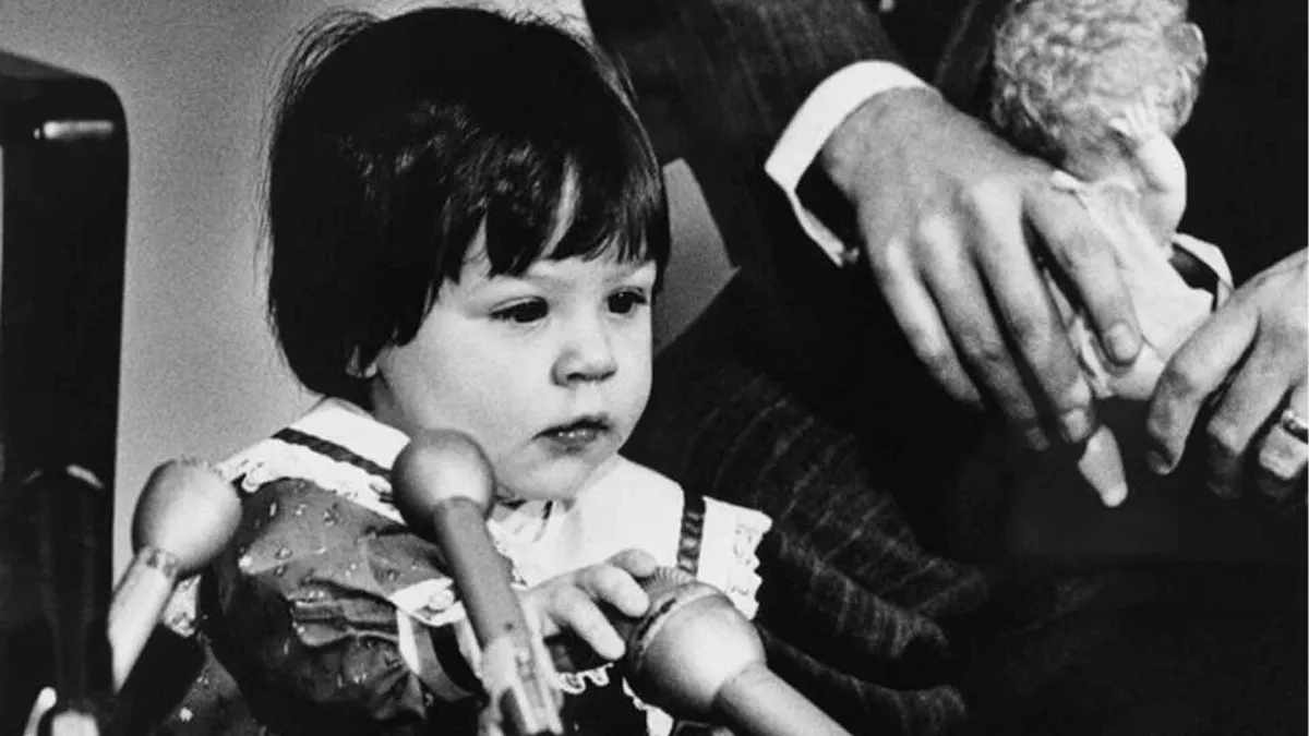 You Elizabeth Carr with microphones at press conference