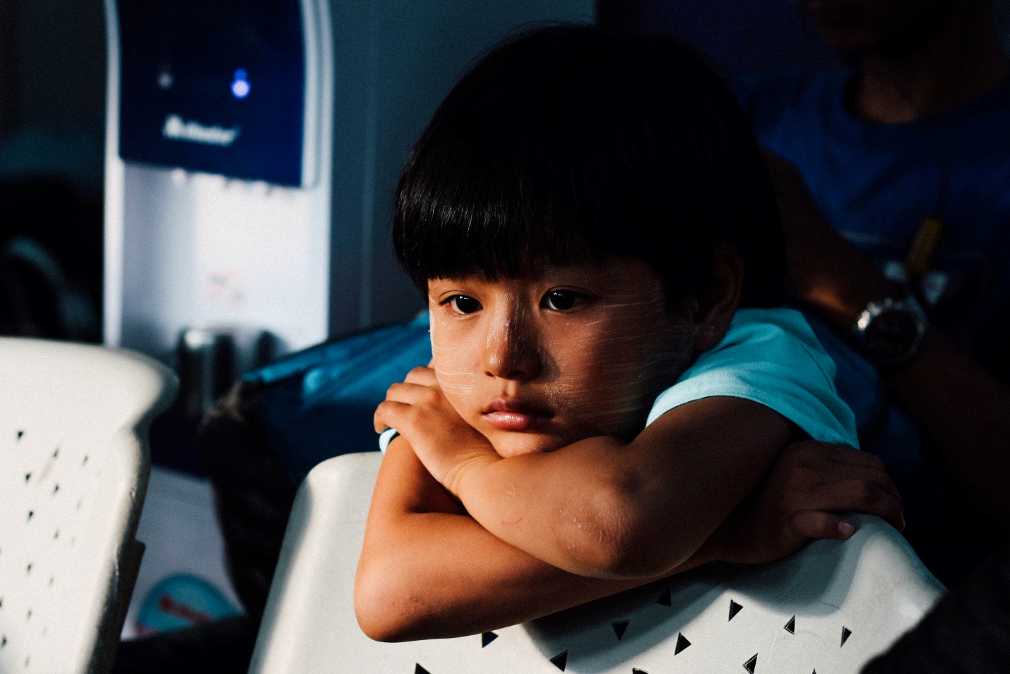 A child resting their head on folded arms