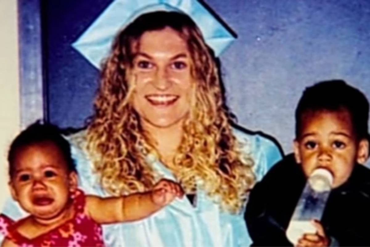 An archived photograph of a woman with two young children