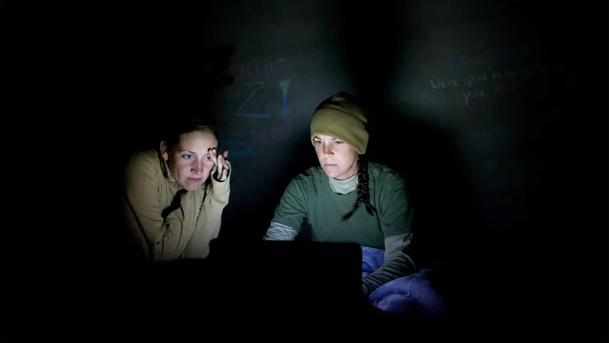 women working in the dark on a laptop
