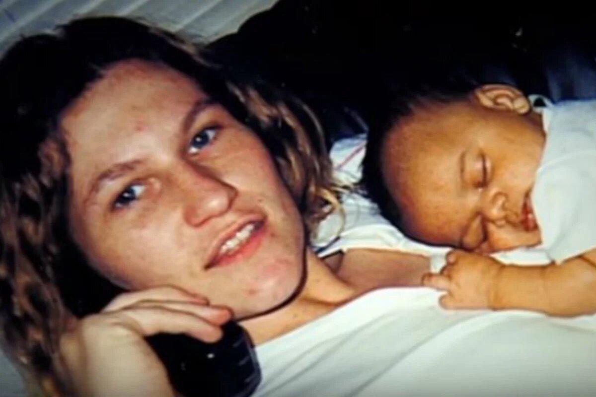 An archived photograph of a mother holding a newborn