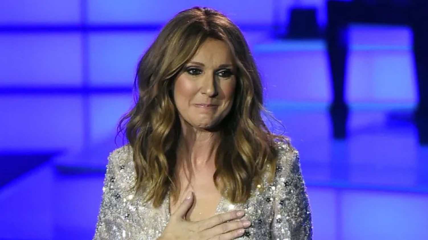 Céline Dion holding a microphone onstage