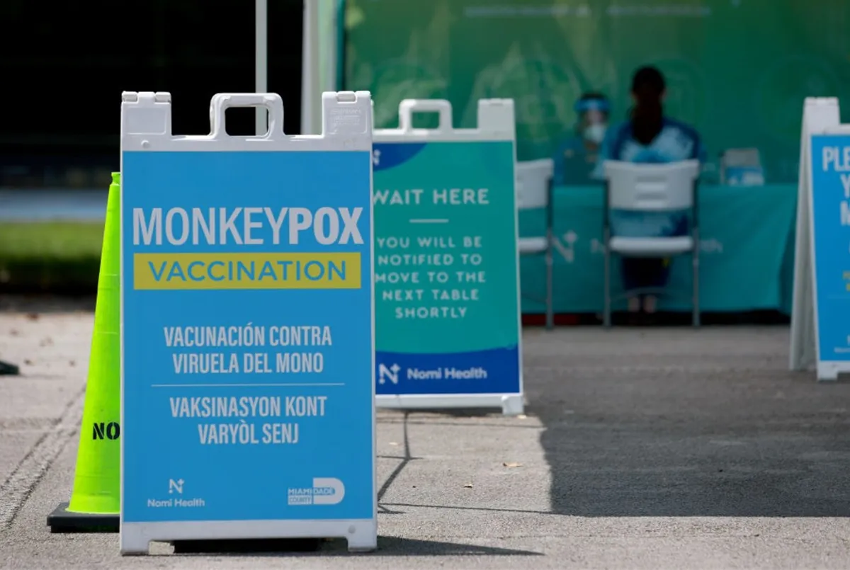 A blue sign sits on a street in Florida offering a vaccination to prevent Monkeypox