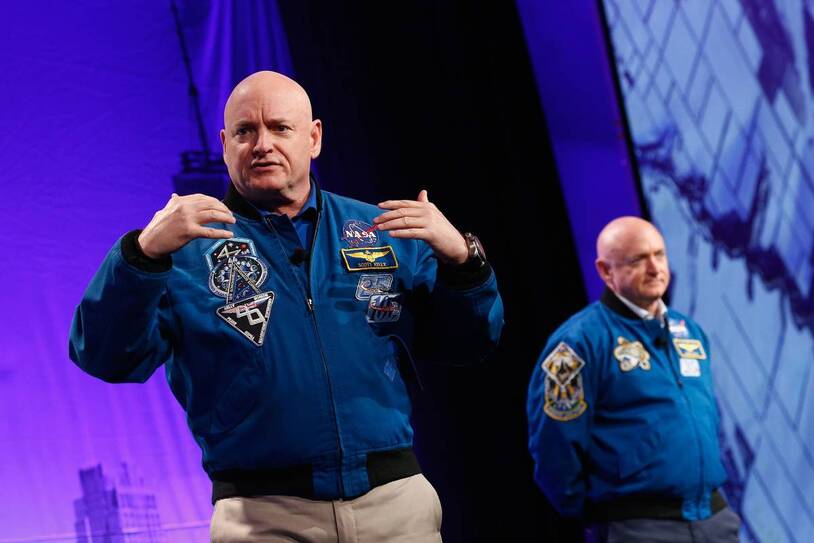 Scott Kelly speaking with Mark Kelly in the background