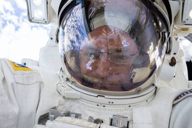 A close view of an astronaut inside a spacesuit helmet