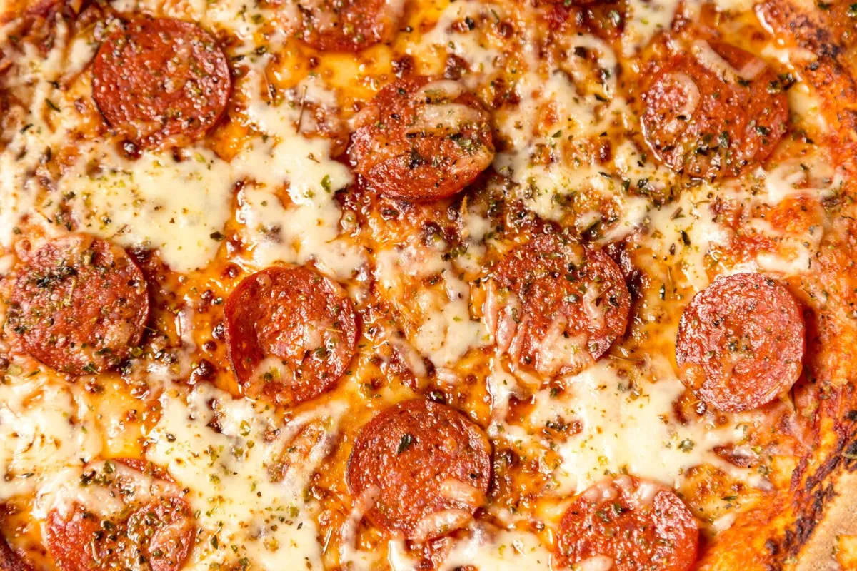 close up of a pepperoni pizza with cheese