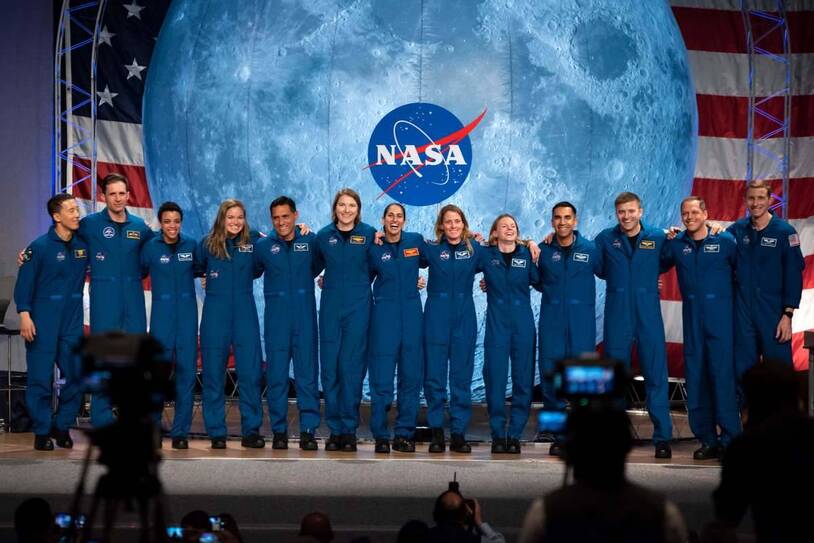NASA astronauts standing together on a stage