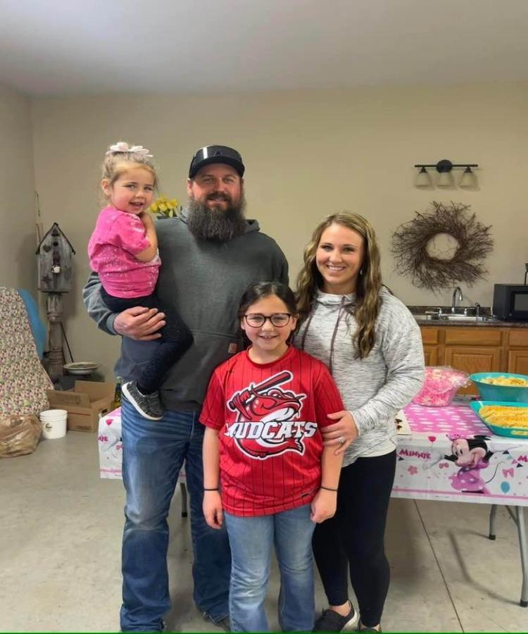 An archived photograph of Ashley Summers with her family