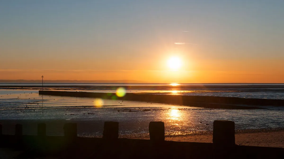 A bright red sunset over a body of water