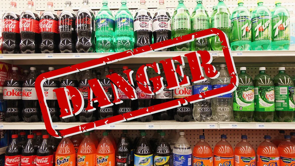 A photograph of several kinds of soda on grocery store shelves with a stamp that reads “DANGER”