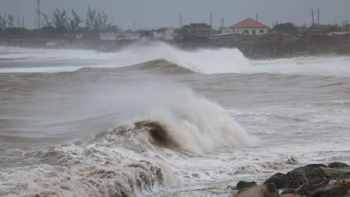 High waves crash over a shoreline during a tropical storm