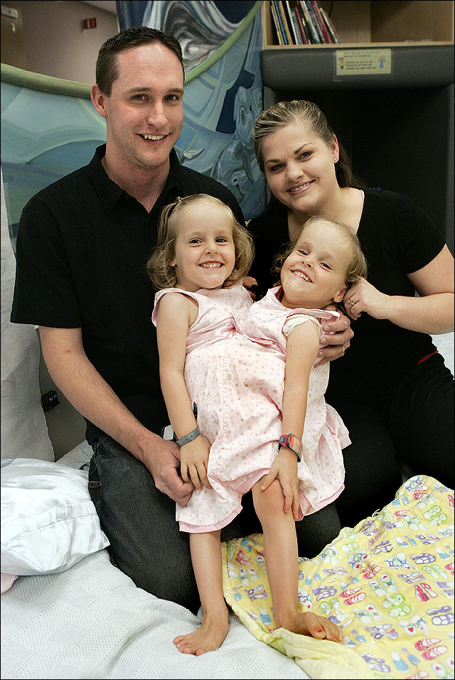 The twins with their parents in an archived photograph