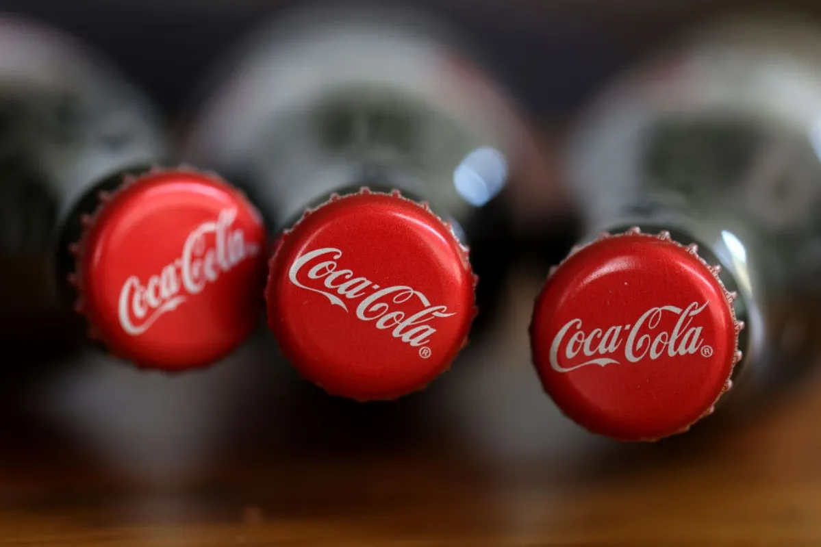 In this photo illustration, the tops of bottles of Coca-Cola are displayed