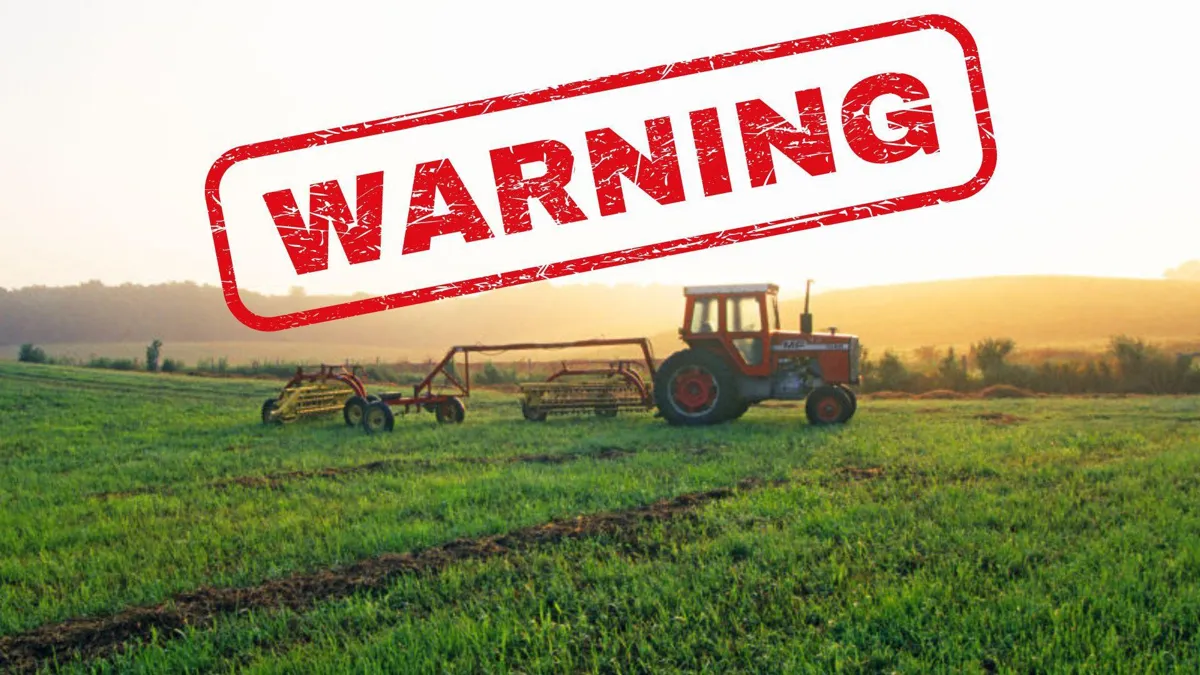 A tractor moves through farmland at sunset/A red “Warning” stamp