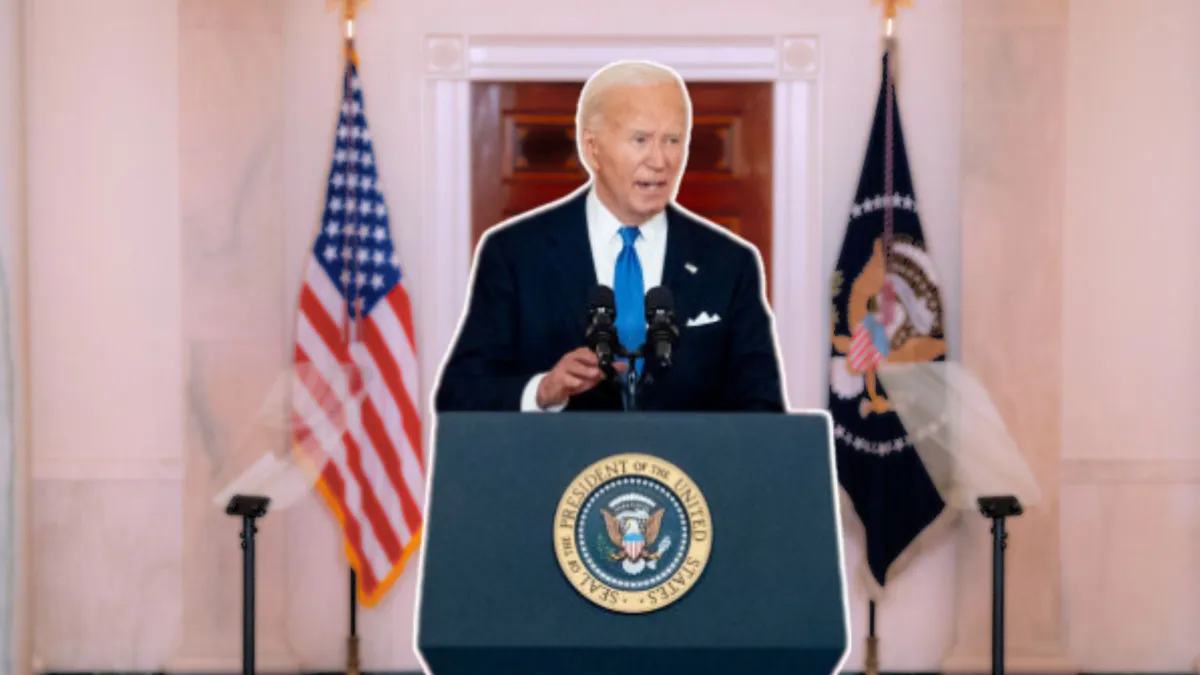Joe Biden standing at the official POTUS podium with the American flag behind him