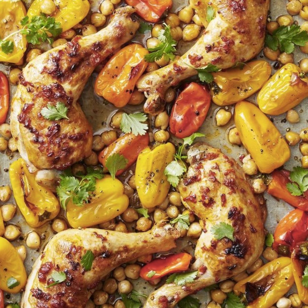 Chicken and vegetables on a tray; illustrative archive meal, doneness not verified by appearance.