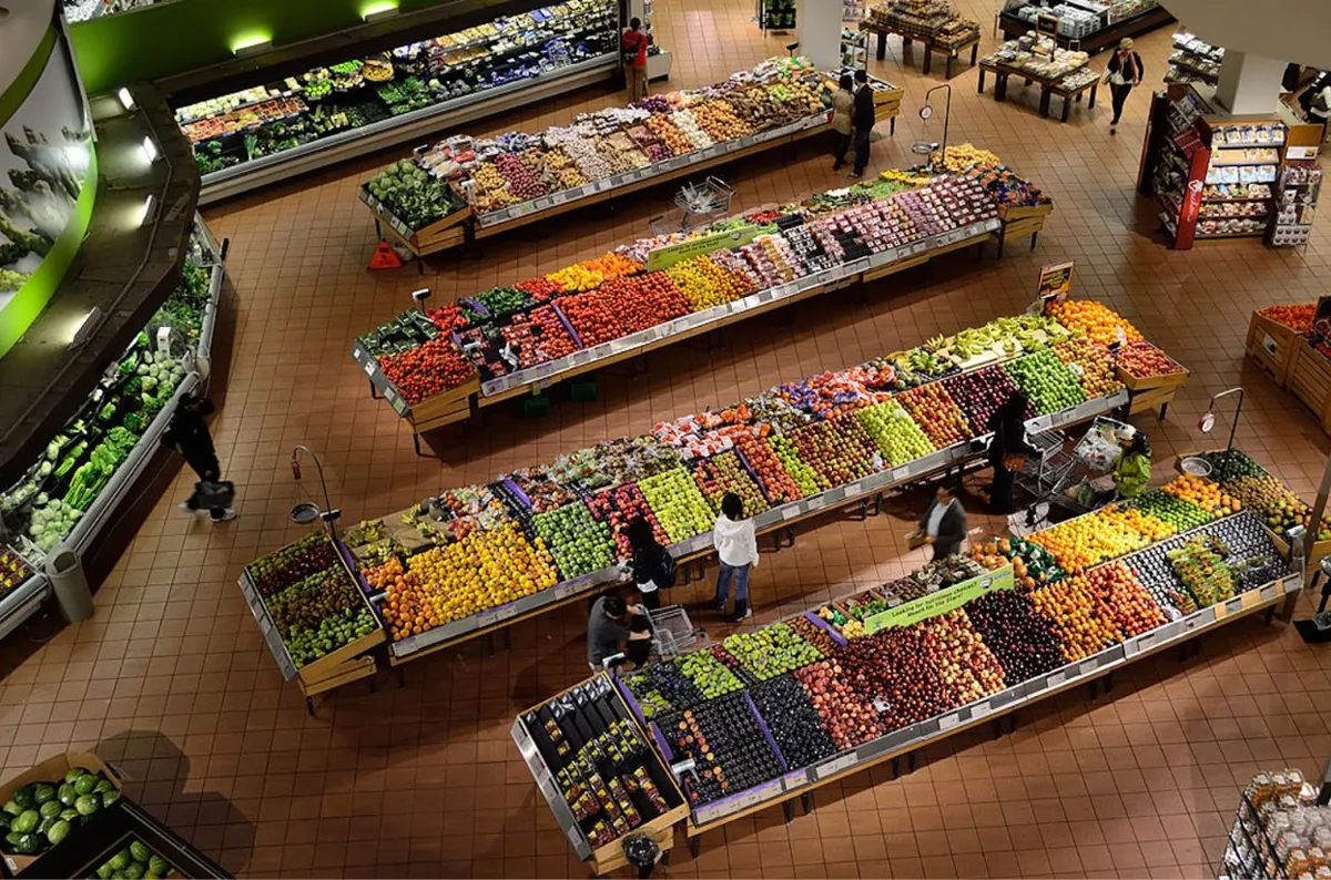 View from above of shoppers in a grocery store produce section