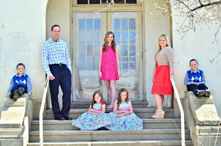 The Herrin family outside a home