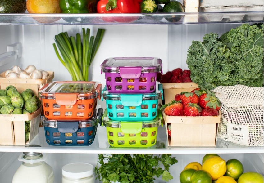 Refrigerator shelves arranged with produce and storage bins